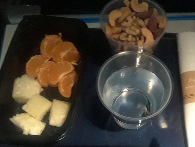 Story from Jam Press (Vegan Flight Meal)  Pictured: Juanita's disappointing first meal on the KLM flight of Pineapple, Satsuma and nuts.  Vegan passenger given fruit and nuts as hot meal on six hour flight  A vegan passenger has slammed an airline after claiming she was given fruit and nuts as a hot meal.  Juanita Headley had been travelling from Accra, Ghana to London Heathrow with airline KLM.  The motivational speaker had already opted for a hot meal on board Ã¢â¬â as part of the complimentary service.  But when on board the six-hour connecting flight, she said she was given pineapple pieces, a tangerine and a handful of nuts.  A few hours later, she claimed crew gave her a cold vegan wrap, a banana and an additional bowl of nuts.  She has slammed KLM as 