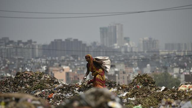 NEW DELHI, INDIA - SEPTEMBER 5: Waste picker in Ghazipur on September 5, 2017 in New Delhi, India. Having failed to find a place for disposing the garbage in east Delhi, the municipal corporation on Monday decided to continue dumping garbage at Ghazipur landfill site. This is despite Lieutenant Governor Anil Baijal ordering an immediate stop on dumping waste at the landfill after a part of it collapsed on September 1 killing two persons. (Photo by Ravi Choudhary/Hindustan Times via Getty Images)