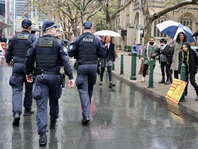 Police patrol the area around Sydney Town Hall on Saturday morning. Picture: Tim Hunter