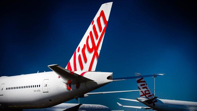 Virgin Australia aircraft are seen parked on the tarmac at Brisbane International Airport. Picture: Patrick Hamilton/ AFP.