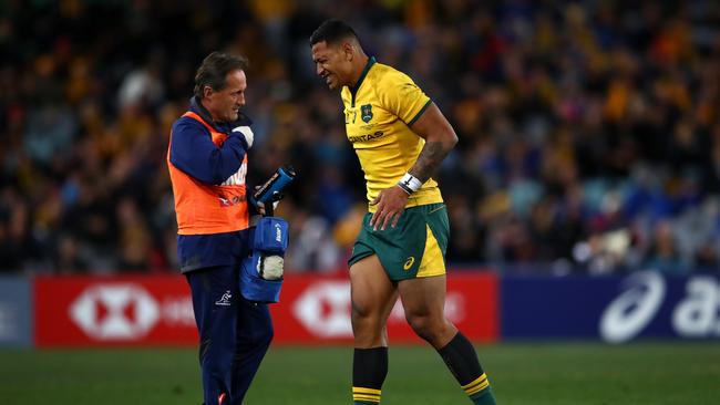 Israel Folau leaves the field injured. (Photo by Cameron Spencer/Getty Images)