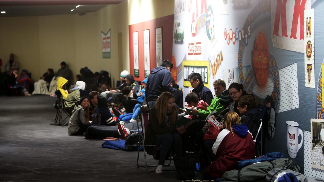 Krispy Kreme fans lined up in the drive-through to avoid the rain before the opening at 10am Picture: Simon Cross