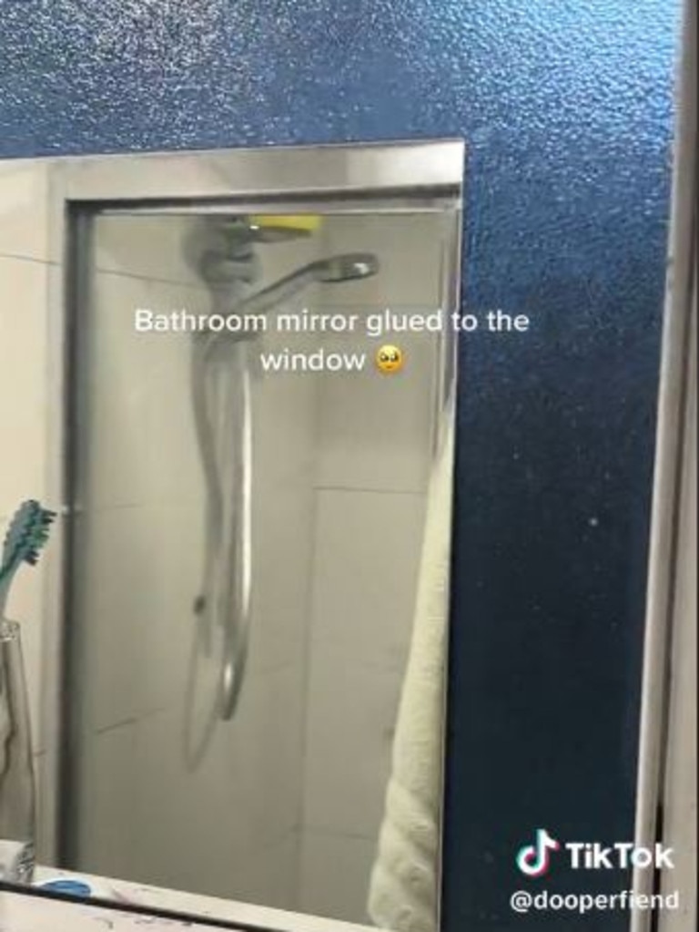 The bathroom mirror is apparently ‘glued’ to the window. Picture: @dooperfiend/TikTok