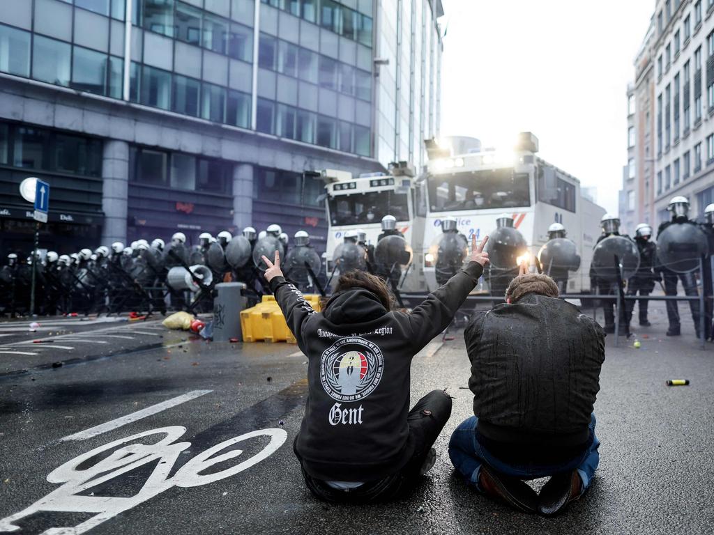 Protesters sat in front of riot police after proceedings got a little heated in Brussels