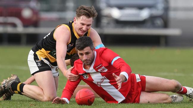 South Bendigo coach Nathan Horbury, right, battles for the ball with Kyneton’s Louis Thompson at the QEO last season. Picture: Yuri Kouzmin