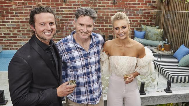 ‘It’s a bargain!’ ... Hughesy with Josh and Elyse after purchasing their home.