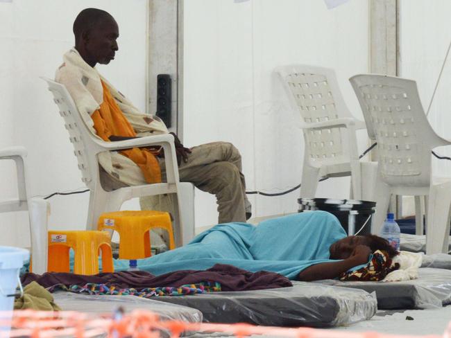 Waiting game ... Ebola patients rest in the high-risk area of Medecins Sans Frontieres’ Elwa hospital in Monrovia. Picture: AFP