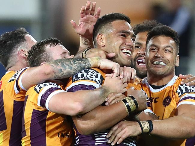 Joe Ofahengaue celebrates with team mates after scoring a try against the Titans in round 17. Picture: Getty