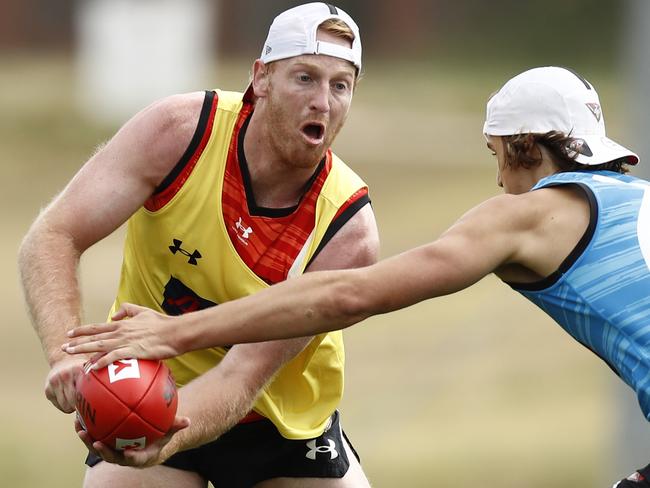 MELBOURNE, AUSTRALIA - NCA NewsWire Photos December 18, 2020:   Aaron Francis of the Bombers handpasses the ball during an Essendon Bombers training session at The Hangar in Melbourne, Victoria. Picture: NCA NewsWire / Daniel Pockett