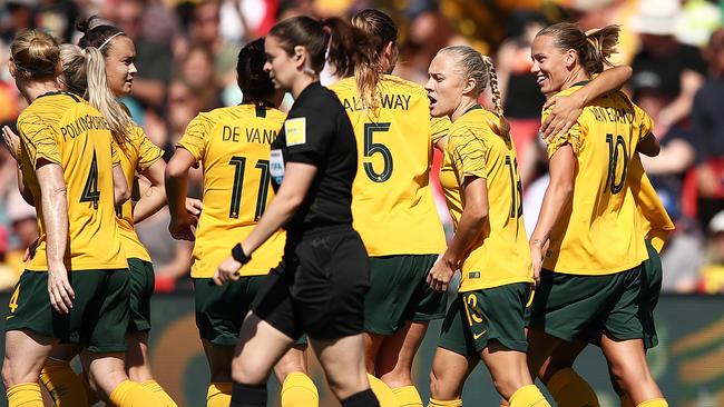 Emily van Egmond of Australia (right) celebrates with teammates after scoring against Chile on Saturday. Picture: Getty Images