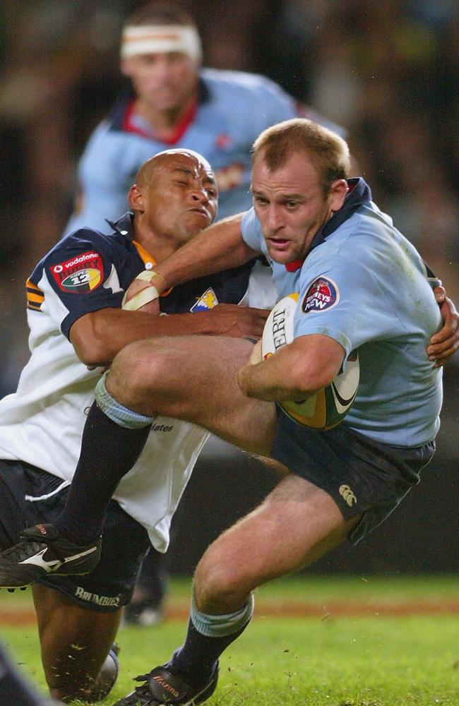 NSW halfback Chris Whitaker is wrapped up by Brumbies opposite George Gregan in the 2002 Super 12 semi-final.