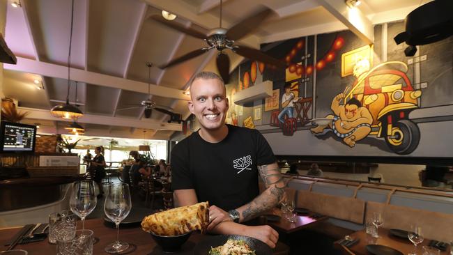 Matt Sinclair at his restaurant Sum Yung Guys at Sunshine Beach, holding the spicy chicken larb and roti. Pic Mark Cranitch.