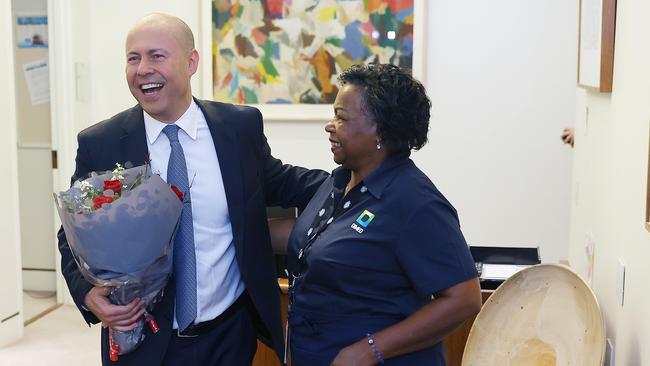 Treasurer Josh Frydenberg’s budget day at work began promisingly enough with a gift of flowers from long-serving Parliament House worker Luzia Borges. Picture: NCA NewsWire / Gary Ramage