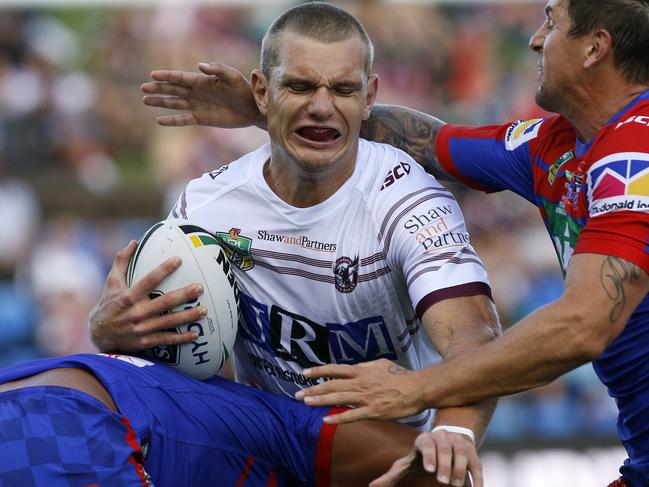 Tom Trbojevic of the Sea Eagles is tackled by Mitchell Pearce during the Round 1 NRL match between the Newcastle Knights and the Manly-Warringah Sea Eagles at McDonald Jones Stadium in Newcastle, Friday, March 9, 2018. (AAP Image/Darren Pateman) NO ARCHIVING, EDITORIAL USE ONLY