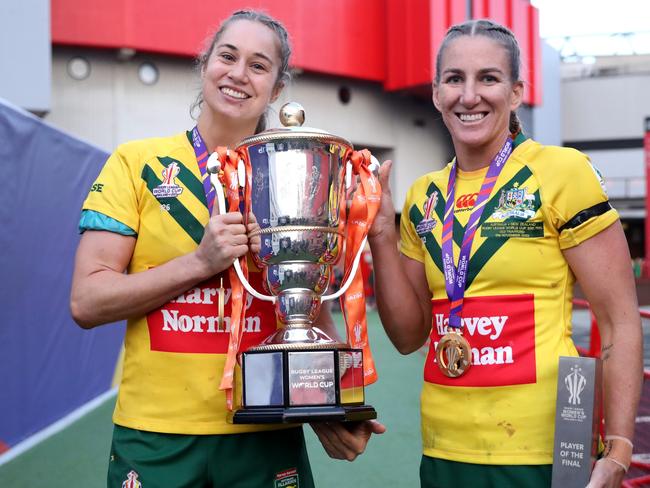 MANCHESTER, ENGLAND - NOVEMBER 19: Kezie Apps and Ali Brigginshaw of Australia celebrate with the Women's Rugby League World Cup trophy and winners medals following the Women's Rugby League World Cup Final match between Australia and New Zealand at Old Trafford on November 19, 2022 in Manchester, England. (Photo by Charlotte Tattersall/Getty Images for RLWC)