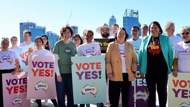 Curtin MP Kate Chaney, sixth from left, Brand MP Madeleine King, sixth from right, and Senator Dorinda Cox, third from right, at a Yes campaign event in Perth.