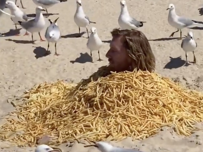 Michael buried himself from the neck down on Surfers Paradise beach. Picture: Instagram