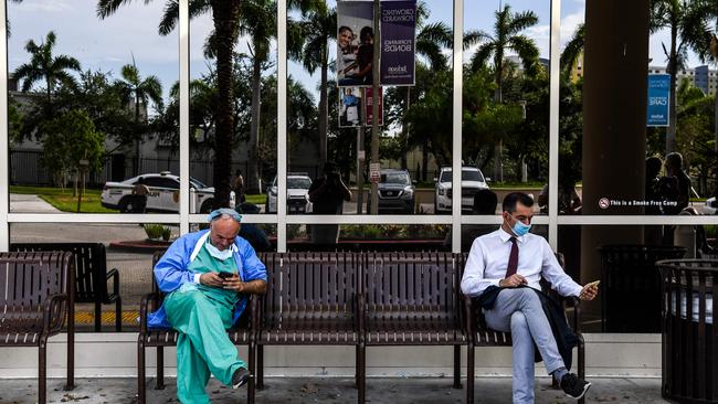 A doctor, left, wearing personal protective equipment (PPE) outside Jackson Memorial Hospital in Miami. Picture: AFP