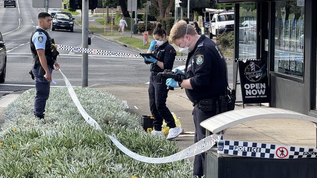 Forensics officers inspecting the Merrylands barbershop. Picture: Aymon Bertah