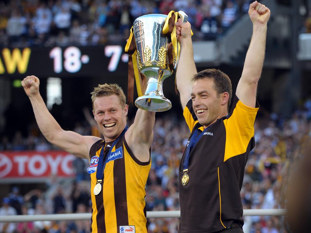 Hawthorn captain Sam Mitchell and coach Alastair Clarkson hold aloft the premiership cup in 2008.