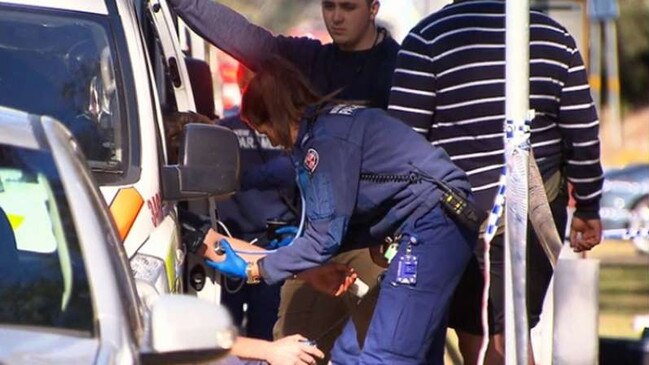 Paramedics treat the officer on scene after he was allegedly stabbed in Marsfield last August. Picture: Channel 9