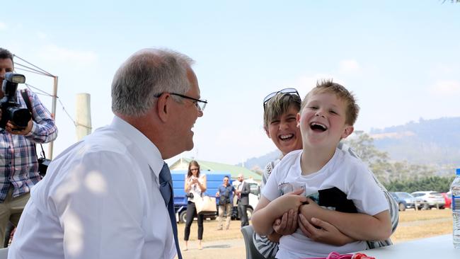 Prime Minister Scott Morrison meets Huon Valley residents Luan Berry and her son Lachie Berry at the evacuation centre in Huonville. Picture: LUKE BOWDEN 