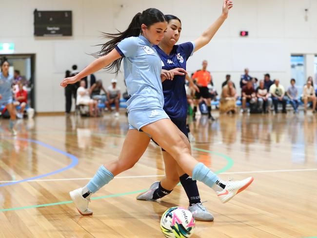 Action between Football NSW Storm and Football NSW Lightning in the U17 girls on day one of the 2025 National Futsal Championships in Melbourne. Picture: Graeme Furlong