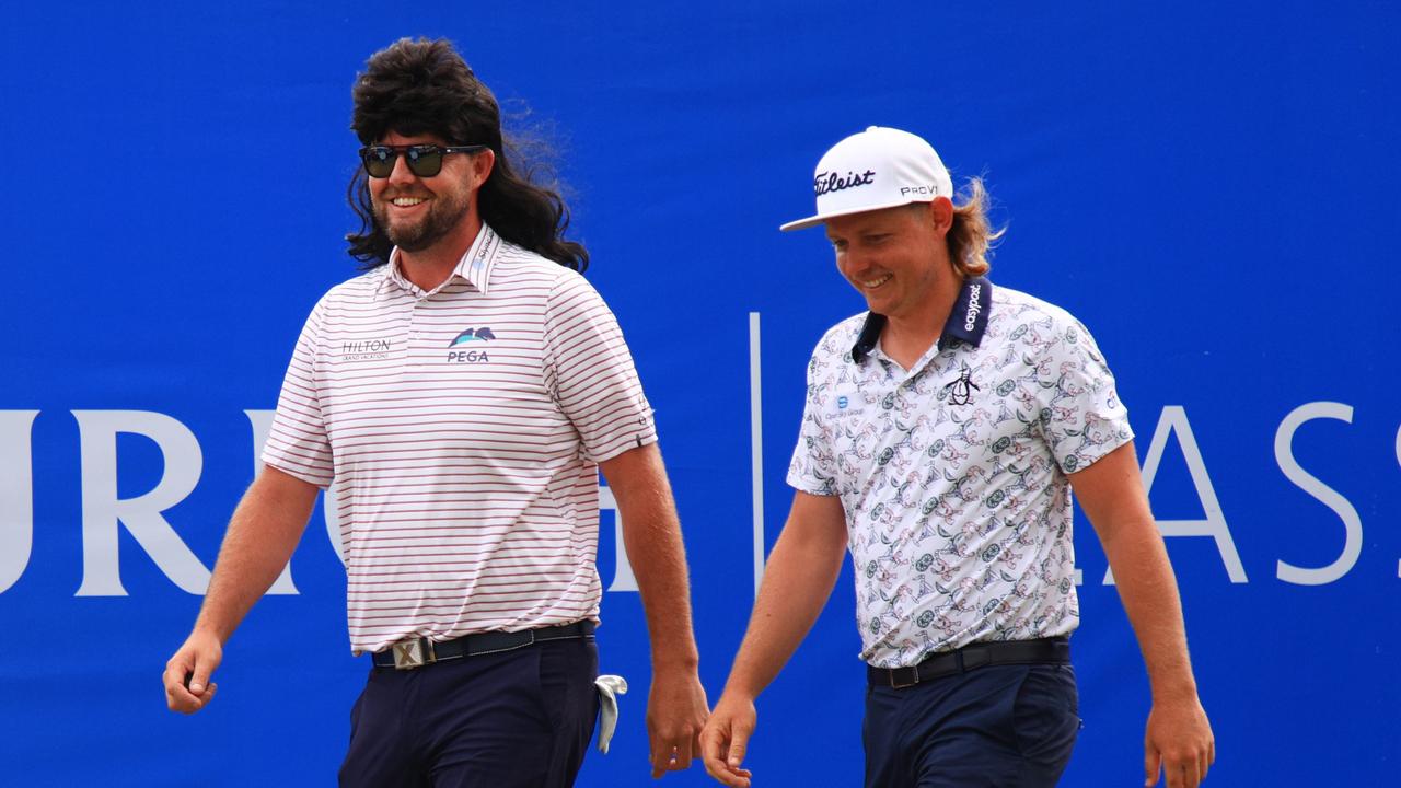 Marc Leishman of Australia wore a mullet wig as he walked out with his partner Cameron Smith on the first tee during the Zurich Classic in New Orleans. Picture: Mike Ehrmann/Getty Images/AFP