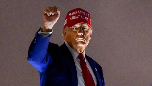 US President Donald Trump pumps his fist as he boards Air Force One before departing Miami International Airport. Picture: AFP
