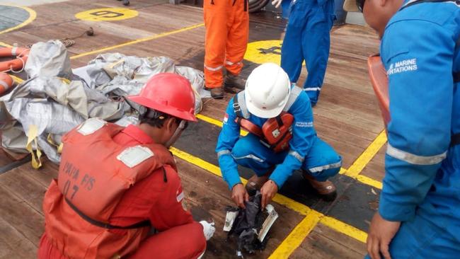 Search and rescue officers examines debris from a Lion Air plane that crashed a short time after take-off from Jakarta. Picture: Sutopo Purwo Nugroho - @Sutopo_PN/Twitter