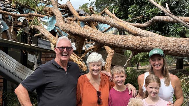 The Hanson family in front of the tree which crashed through Brooke’s childhood room. Left to Right: Ian Hanson, Sue Hanson, Billy Clarke, Matilda Clarke, Brooke Hanson. Picture: Robert White.