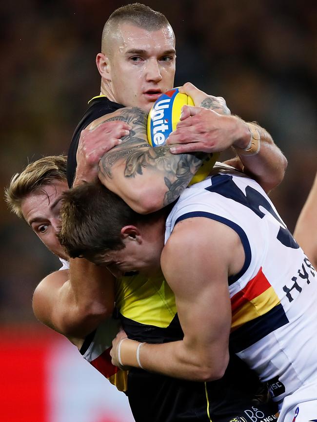 Dustin Martin of the Tigers is tackled by Daniel Talia (left) and Matt Crouch of the Crows on Friday night. Picture: Getty Images