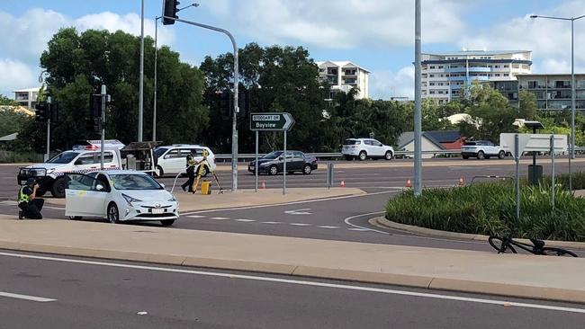 Police investigators at the scene of the crash between a car and a cyclist near the intersection of Tiger Brennan Dr and Stoddart Dr this morning