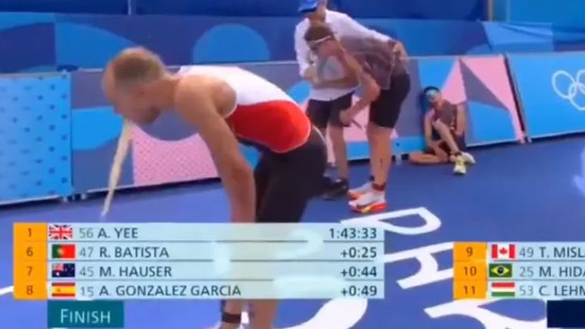 Canada’s Tyler Mislawchuk throws up after crossing the finish line following the Men’s Triathlon at the 2024 Paris Olympics.