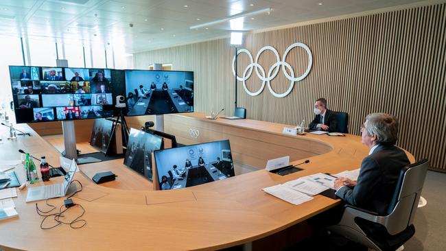 IOC president Thomas Bach, right, attends an IOC Executive Board meeting via video link in Lausanne to announce that Brisbane iss the preferred candidate to host the 2032 Games. Picture: AFP