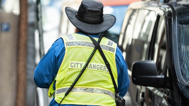 A city ranger giving parking infringement notices to street parked cars in Sydney CBD. Picture: James Gourley