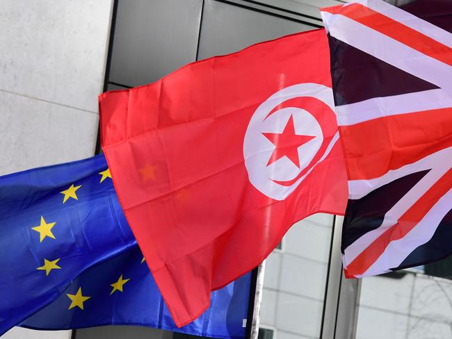 (L-R) The EU, Turkish and Union Jack flags flutter in the wind ahead of the 60th anniversary of "The Treaty of Rome" near the EU institutions, in Brussels on March 21, 2017. The Treaty of Rome, officially the Treaty establishing the European Economic Community (TEEC), is an international agreement that brought the creation of the European Economic Community (EEC), signed on March, 25, 1957 by Belgium, France, Italy, Luxembourg, the Netherlands and West Germany, leading to the creation of the EU. European Council President announced that the European Union's 27 leaders will meet on April 29, 2017 to agree their negotiating lines for Brexit talks after London sends in a formal notification that it wants to leave the EU. / AFP PHOTO / EMMANUEL DUNAND