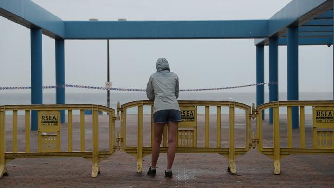 A passer-by at closed Maroubra beach on March 30. Picture: John Grainger