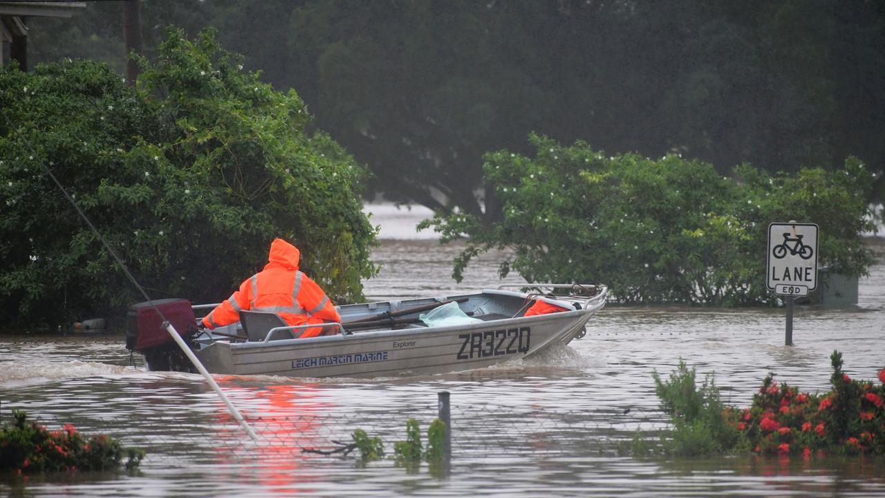 An Ingham resident travels by boat on Monday afternoon in the North Queensland flooding. Photo: Cameron Bates