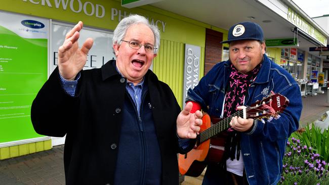 Stephen Fisher with local busker Craig Robertson after he broke out into song during a 2016 council meeting. Photo: Mark Brake