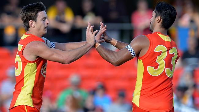 Jarryd Lyons and Aaron Hall celebrate a goal against West Coast.