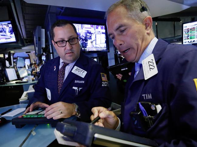 Specialist Brain Fairbrother, left, and trader Timothy Nick work on the floor of the New York Stock Exchange, Tuesday, Aug. 4, 2015. Stocks are mostly higher in early trading as investors focus on the latest earnings and deal news. (AP Photo/Richard Drew)