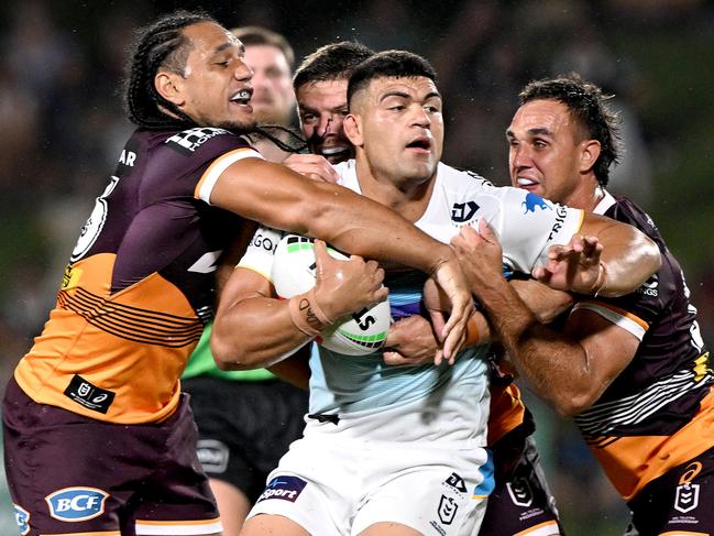 SUNSHINE COAST, AUSTRALIA - FEBRUARY 12: David Fifita of the Titans is wrapped up by the defence during the NRL Trial Match between the Brisbane Broncos and Gold Coast Titans at Sunshine Coast Stadium on February 12, 2023 in Sunshine Coast, Australia. (Photo by Bradley Kanaris/Getty Images)