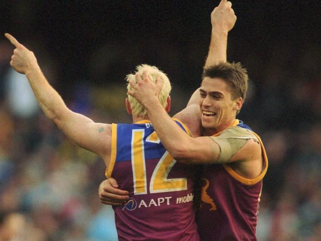 Simon Black knows what it takes to go back-to-back. The Lions great is pictured with Jason Akermanis during the 2002 Grand Final.