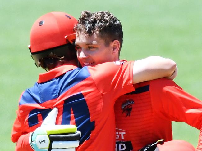 Travis Head and Alex Carey hug it out after the wicketkeeper made a century against Queensland late last month.