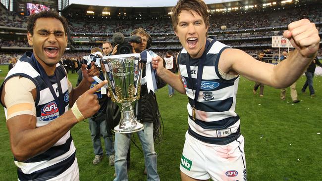 Mackie celebrates the 2011 premiership win with with Travis Varcoe.