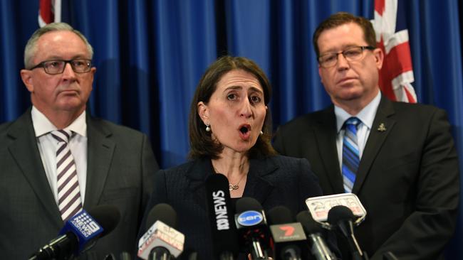 Health Minister Brad Hazzard with Premier Gladys Berejiklian and Police Minister Troy Grant on Tuesday. Picture: AAP