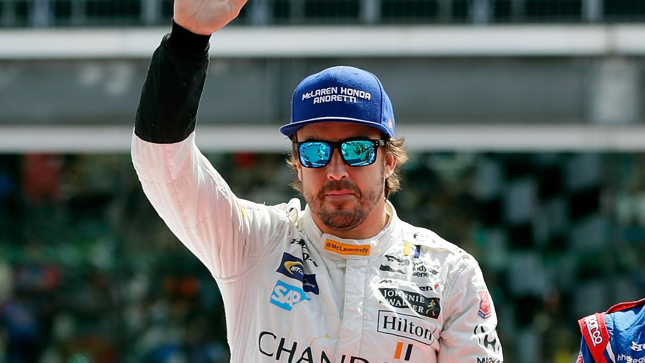 Fernando Alonso waves during driver introductions ahead of the 101st running of the Indianapolis 500 in 2017.