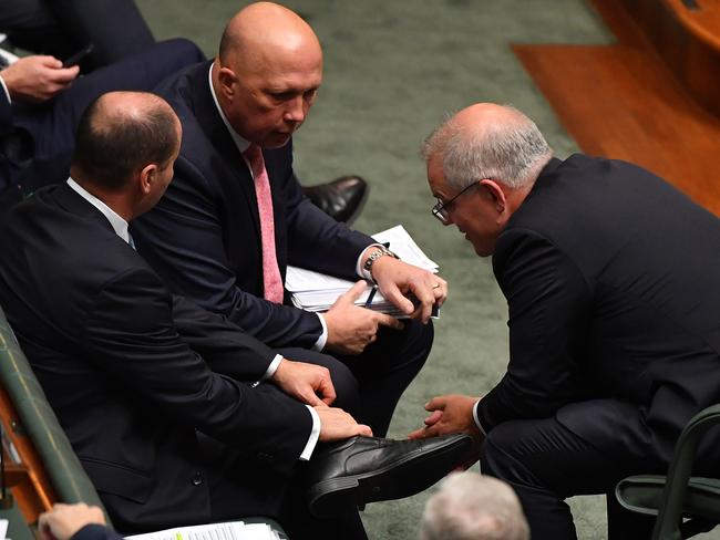 Peter Dutton speaks with Scott Morrison and Josh Frydenberg. Picture: Getty Images