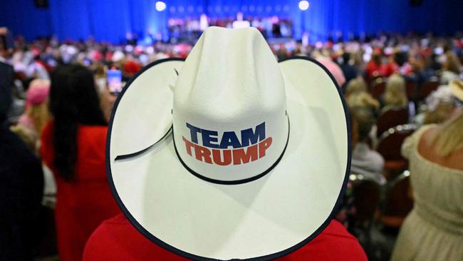 A supporter of former US President and Republican presidential candidate Donald Trump wears a "Trump Team" hat during a campaign rally. (Photo by Jim WATSON / AFP)